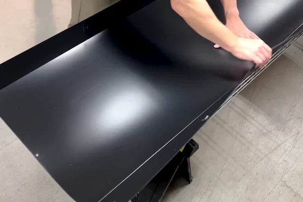 Lowering the folded liner into the wire basket.